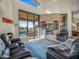 Cozy living room with a fireplace, leather seating, and expansive views of the outdoor pool and patio at 9878 N 79Th Pl, Scottsdale, AZ 85258