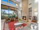 Elegant living room boasting high ceilings, a stone fireplace, and expansive windows at 9878 N 79Th Pl, Scottsdale, AZ 85258