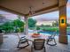 Inviting covered patio with fire pit and outdoor seating next to a sparkling pool at 9878 N 79Th Pl, Scottsdale, AZ 85258