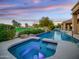 Inviting spa and pool with scenic views and stone features, surrounded by well-maintained landscaping at 9878 N 79Th Pl, Scottsdale, AZ 85258