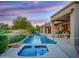 Outdoor pool and spa area with lush landscaping, perfect for relaxation and entertainment, viewed at dusk at 9878 N 79Th Pl, Scottsdale, AZ 85258