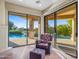 Comfortable sitting area next to glass doors leading to a pool and manicured grounds at 9878 N 79Th Pl, Scottsdale, AZ 85258