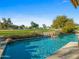 Sparkling swimming pool with rock waterfall and golf course views at 9878 N 79Th Pl, Scottsdale, AZ 85258