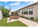 Serene backyard with a hot tub, lush landscaping, and a private outdoor space ideal for relaxation and enjoyment at 10006 E Rotation Dr, Mesa, AZ 85212