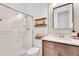Bright bathroom with walk-in shower, floating shelves, and a modern vanity at 10006 E Rotation Dr, Mesa, AZ 85212