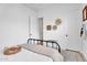 Minimalist bedroom featuring a black metal bed frame, patterned rug, and neutral decor at 10006 E Rotation Dr, Mesa, AZ 85212