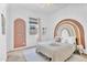 Charming bedroom with a rainbow accent wall, cozy furnishings, and bright natural light at 10006 E Rotation Dr, Mesa, AZ 85212