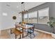 Dining room with modern light fixture, natural light, and neutral tones at 10006 E Rotation Dr, Mesa, AZ 85212