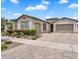 Charming single-story home featuring a brick driveway, manicured landscaping, and a two-car garage at 10006 E Rotation Dr, Mesa, AZ 85212