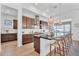 Contemporary kitchen featuring a large island with seating, stainless steel appliances, and stylish pendant lights at 10006 E Rotation Dr, Mesa, AZ 85212