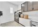 Convenient laundry room with modern washer and dryer, ample storage, and neutral color palette at 10006 E Rotation Dr, Mesa, AZ 85212