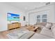 Bright living room with a sectional sofa, hardwood floors, a modern TV console, and neutral decor at 10006 E Rotation Dr, Mesa, AZ 85212