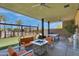 Cozy outdoor lounge area with comfortable seating, a fire pit, and a ping pong table at 10006 E Rotation Dr, Mesa, AZ 85212