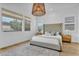 Main bedroom featuring a tufted headboard, plush bedding, and natural light at 10006 E Rotation Dr, Mesa, AZ 85212