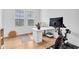Home office featuring bright light through plantation shutters and modern Peloton equipment at 10006 E Rotation Dr, Mesa, AZ 85212