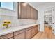 Large butler's pantry features granite countertops, tiled backsplash and ample storage space at 10006 E Rotation Dr, Mesa, AZ 85212