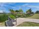 Park view showcasing a serene pond, lush greenery, a walking path, and a calming atmosphere at 10006 E Rotation Dr, Mesa, AZ 85212