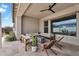 Inviting covered patio with comfortable seating, a ceiling fan, and a modern fire pit for outdoor relaxation at 10006 E Rotation Dr, Mesa, AZ 85212