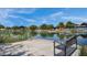 Picturesque pond view with a bench, lush vegetation, and a tranquil setting for relaxation and reflection at 10006 E Rotation Dr, Mesa, AZ 85212
