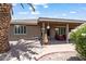Covered patio seating area with landscaped backyard and desert flora at 11025 E Nichols Ave, Mesa, AZ 85209
