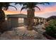 Charming backyard with lush landscaping, covered patio, and desert rock garden at 11025 E Nichols Ave, Mesa, AZ 85209