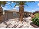 Cozy backyard with desert landscaping, a covered patio, and flowering bushes at 11025 E Nichols Ave, Mesa, AZ 85209