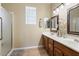 Bathroom featuring double sinks, and a walk-in shower with glass accents at 11025 E Nichols Ave, Mesa, AZ 85209