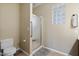 Bathroom features a glass block window, tiled floor, and walk-in shower with glass door at 11025 E Nichols Ave, Mesa, AZ 85209