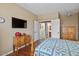 Bedroom offers a TV, wood floors, and ensuite bathroom and laundry entrances at 11025 E Nichols Ave, Mesa, AZ 85209