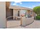 Inviting front porch with elegant iron gate, seating area, and manicured shrubbery at 11025 E Nichols Ave, Mesa, AZ 85209