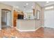 Beautiful kitchen with natural wood cabinets, black appliances, and view to front entry at 11025 E Nichols Ave, Mesa, AZ 85209