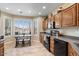 Well appointed kitchen with dark cabinets and a breakfast nook with large picture window at 11025 E Nichols Ave, Mesa, AZ 85209
