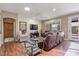 Cozy living room featuring wood floors, neutral paint, and a comfortable seating arrangement at 11025 E Nichols Ave, Mesa, AZ 85209