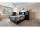 Comfortable main bedroom with a ceiling fan, neutral color palette, and black furniture set at 11025 E Nichols Ave, Mesa, AZ 85209