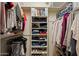 Well-organized walk-in closet with built-in shelving and ample storage space for clothing and accessories at 11025 E Nichols Ave, Mesa, AZ 85209