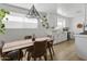 Bright kitchen featuring white cabinets, stainless steel appliances, and a view of the dining area at 1111 E Turney Ave # 3, Phoenix, AZ 85014