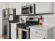 Close up of the kitchen features stainless steel appliances and white countertops at 1111 E Turney Ave # 3, Phoenix, AZ 85014