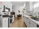 Bright kitchen features white cabinets, stainless steel appliances, and a view of the dining area at 1111 E Turney Ave # 3, Phoenix, AZ 85014