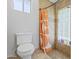 Bright bathroom featuring walk-in shower with glass block window and neutral tile surround at 12639 N 47Th Ave, Glendale, AZ 85304