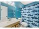 Colorful bathroom with blue walls and a shark-themed shower curtain at 12639 N 47Th Ave, Glendale, AZ 85304