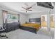 Primary bedroom with a large bed, dresser, and a view into an organized closet at 12639 N 47Th Ave, Glendale, AZ 85304