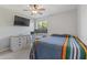 Cozy bedroom featuring a window, desk with monitors, and comfortable bedding at 12639 N 47Th Ave, Glendale, AZ 85304