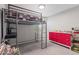 Bedroom with a unique lofted bed and study area, complemented by vibrant red storage at 12639 N 47Th Ave, Glendale, AZ 85304