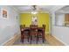 Bright dining room featuring a wooden table and chairs, complemented by a vibrant accent wall at 12639 N 47Th Ave, Glendale, AZ 85304