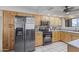 Well-lit kitchen featuring light wood cabinets, stainless steel appliances, and tile flooring at 12639 N 47Th Ave, Glendale, AZ 85304