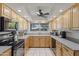 Bright kitchen featuring wooden cabinets, modern appliances, and plenty of counter space at 12639 N 47Th Ave, Glendale, AZ 85304