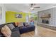 Comfortable living room featuring a brick fireplace, hardwood floors, and natural light at 12639 N 47Th Ave, Glendale, AZ 85304