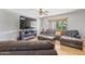 Comfortable living room featuring cozy seating, a large TV, and a stylish fireplace at 12639 N 47Th Ave, Glendale, AZ 85304