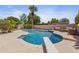 Inviting pool area surrounded by palm trees, lounge chairs, and a diving board at 12639 N 47Th Ave, Glendale, AZ 85304