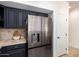Close-up of the kitchen's stainless steel refrigerator and dark cabinets at 12642 N Mountainside Dr # B, Fountain Hills, AZ 85268